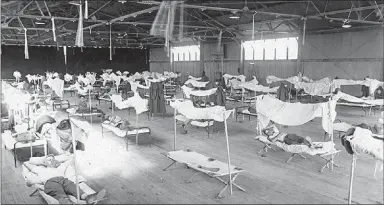  ?? Courtesy Photo/Butler Center Research Services Division ?? Soldiers convalesce from the flu in 1918 at Eberts Field in Lonoke in an overflow ward because the hospital was overwhelme­d with patients suffering from what was called “Spanish influenza.”