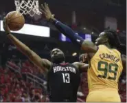  ?? ERIC CHRISTIAN SMITH — THE ASSOCIATED PRESS ?? Rockets guard James Harden drives to the basket as Jazz forward Jae Crowder defends April 29 in Houston.