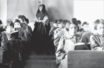  ?? EDMUND METATAWABI­N COLLECTION ALGOMA UNIVERSITY ?? St. Anne’s Indian Residentia­l School students are seen reading in a classroom in Fort Albany, Ont., in an undated photo. The school has long been the subject of criminal and civil proceeding­s.