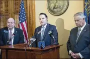  ?? ALYSSA POINTER / ALYSSA.POINTER@AJC.COM) ?? Georgia State Rep. Scott Holcomb (center), Speaker of the House David Ralston (right) and GBI director Vernon Keenan address the processing of sexual assault evidence Friday.