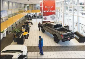  ?? CHONA KASINGER / THE NEW YORK TIMES ?? Customers browse the sales floor Sept. 27 at Bill Korum’s dealership in Pullayup, Wash. Amid a shortage of new cars, many buyers have been forced to kick the tires of overlooked models and brands.