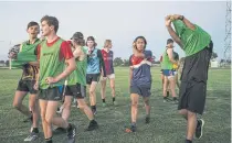  ??  ?? ABOVE Duke Caburnay, 16, second from right, takes part in a football practice in Pyramid Hill.