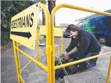  ??  ?? A contractor working on the NBN Constructi­on roll-out