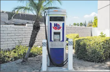 ?? Jae C. Hong The Associated Press ?? An EV charger stands Aug. 26 at a gas station in South El Monte, Calif. By 2035 the state will require automakers to sell only cars that run on electricit­y or hydrogen.