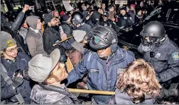  ??  ?? RAGE AT JFK: Police confront protesters at JFK airport Saturday.