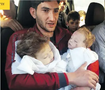  ?? ALAA ALYOUSEF VIA AP ?? Abdulhamid al-Youssef holds his twin babies who were killed during a suspected chemical weapons attack in Syria.