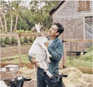  ??  ?? Knight feeds goats June 25 at his farmhouse home.