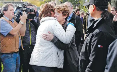  ?? CHAD HIPOLITO, THE CANADIAN PRESS ?? Premier Christy Clark, left, hugs Tofino Mayor Josie Osborne in Tofino on Tuesday.