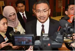  ??  ?? On foreign policy: Hishammudd­in speaking to reporters at Parliament.