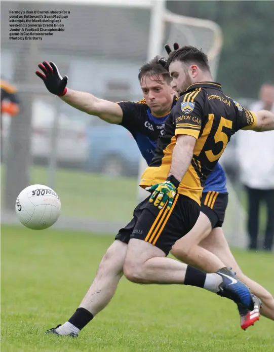  ??  ?? Fermoy’s Cian O’Carroll shoots for a point as Buttevant’s Sean Madigan attempts the block during last weekend’s Synergy Credit Union Junior A Football Championsh­ip game in Castletown­roche Photo by Eric Barry