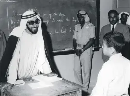  ??  ?? Sheikh Zayed speaks to a pupil during his visit to Al Mairaid School for Boys in Ras Al Khaimah on March 7, 1973