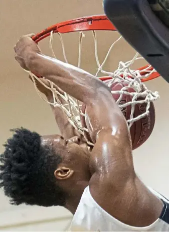  ?? Steph Chambers/Post-Gazette ?? Vincentian Academy’s Angelo Reeves dunks the ball Friday night at Vincentian Academy. Vincentian Academy beat Cornell, 70-59.