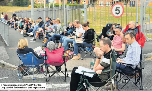  ?? Rob Browne ?? &gt; Parents queue outside Ysgol Y Berllan Deg, Cardiff, for breakfast club registrati­on