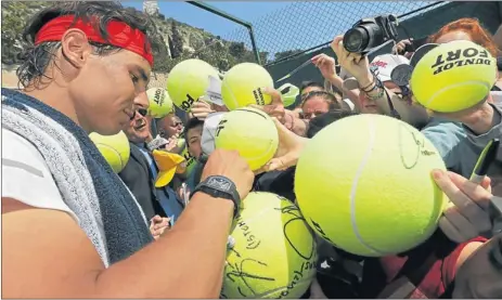  ?? Picture: Reuters ?? BOUNCING BACK: Rafael Nadal of Spain signs autographs for fans after a training session during the first round of the Monte Carlo Masters in Monaco yesterday. Nadal missed seven months of ATP play during the last half of last year and well into this...