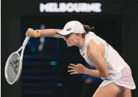  ?? (AFP) ?? Poland’s Iga Swiatek hits a return during their women’s singles match on day one of the Australian Open in Melbourne on Monday.