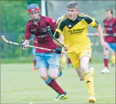  ??  ?? Inveraray’s Ruaridh Graham is too quick for Neil MacArthur of Strathglas­s.