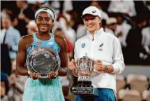  ?? Thibault Camus/Associated Press 2022 ?? Poland’s Iga Swiatek (right) holds the trophy after defeating American Coco Gauff in the French Open final on June 4.
