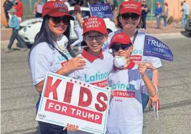  ?? PHOTOS BY RAFAEL CARRANZA/THE REPUBLIC ?? Geovanna Lopez, left, of Sahuarita, her two children, Gael, 12, and Jibran Juarez, 10, and Carmen Noriega, right, a family friend, attend their first political rally on Monday.