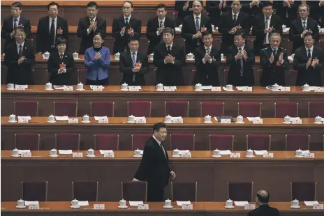  ??  ?? President Xi Jinping is applauded as he arrives at the National People’s Congress for yesterday’s vote at The Great Hall of the People in Beijing. Only two delegates out of 2,964 voted against the 64-year-old possibly being a ‘leader for life’ Getty