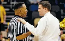  ?? THE ASSOCIATED PRESS ?? Former UTC coach Will Wade, now at VCU, talks with an official in a timeout during a game against Rhode Island in the Atlantic 10 tournament championsh­ip game Sunday in Pittsburgh.