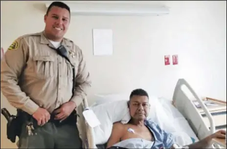  ?? PHOTO COURTESY OF DEPUTY RONALD SNEED ?? Palmdale Sheriff’s Station Deputy Garcia visits Palmdale resident Vincent Vasquez life Sunday by applying a tourniquet from his duty belt to the man’s left arm. in the hospital. Garcia saved Vasquez’s