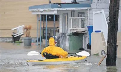  ?? CP PHOTO ?? A man paddles a kayak on Rue Jacques-Cartier in Gatineau, Que., as significan­t rainfall continues to cause flooding on Friday.