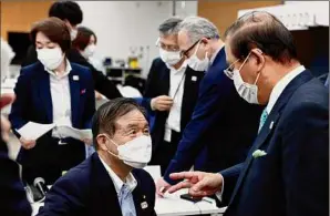  ?? Behrouz Mehri / Associated Press ?? Tokyo 2020 CEO Toshiro Muto, right, said many sponsors, federation officials and others would be allowed to attend events.