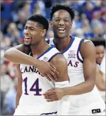  ?? Nati Harnik Associated Press ?? MALIK NEWMAN (14) and Marcus Garrett celebrate after the top-seeded Jayhawks defeated No. 2 seed Duke 85-81 in overtime.