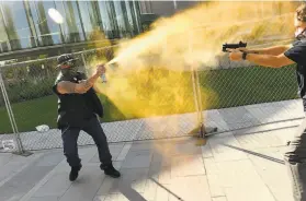  ?? Helen H. Richardson / Denver Post ?? A protester sprays Mace at an armed man, who allegedly shoots him to death, during dueling rightand leftwing demonstrat­ions in Denver on Saturday.