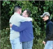  ?? MATT BUTTON — THE BALTIMORE SUN VIA AP ?? Unidentifi­ed bystanders embrace as police and Emergency Medical Services respond to a shooting at a business park in the Edgewood area of Harford County, Md., Wednesday.