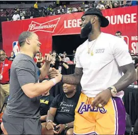  ?? Ethan Miller Getty I mages ?? CLEVELAND COACH Tyronn Lue greets LeBron James after a quarterfin­al summer league game between the Lakers and the Detroit Pistons in Las Vegas.