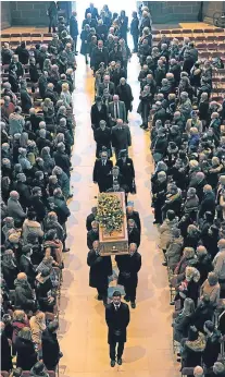  ?? Pictures: Pa/getty. ?? The coffin is carried in during the funeral service of Sir Ken Dodd at Liverpool Anglican Cathedral. Right: a mourner in a Union flag coat holds an image of Sir Ken Dodd and his wife Lady Anne.