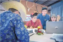  ??  ?? From left, Trey Mitchell, 15, and Wyatt Mortenson, 16, both from Santa Fe, Jesse Maxam, 16, from Corrales, and Cheyanne Carlisle, 17, from Tohatchi, work on a ranch management plan for the CS Ranch near Cimarron.