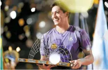  ?? AFP-Yonhap ?? Sebastian Baez holds his trophy after winning the ATP 500 Rio Open tennis men’s singles final match against Mariano Navone in Rio de Janeiro, Brazil, Sunday.