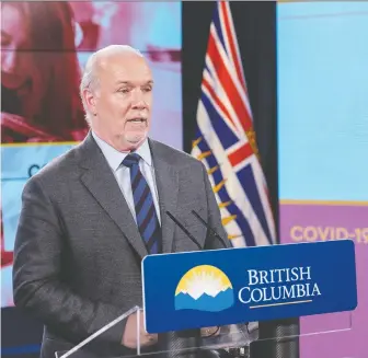  ?? DON CRAIG/GOVERNMENT OF B.C. ?? Premier John Horgan says workers who fall ill with COVID-19 shouldn't have to choose between staying home and going to work sick because they can't afford the loss of wages.