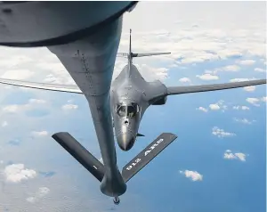  ??  ?? Above: a B-1B Lancer, deployed to Guam, receives fuel over the Pacific Ocean. Left: General Joseph Dunford, right, speaks with United States Forces Korea Commander General Vincent Brooks at Osan Air Base in South Korea.