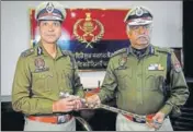  ??  ?? DGP Dinkar Gupta (L) takes over the baton from outgoing Punjab Police chief Suresh Arora in Chandigarh on Thursday. KESHAV SINGH/HT