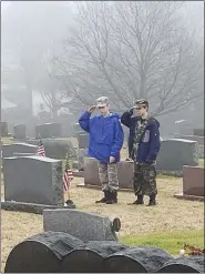  ?? COURTESY OF RAY KOCHEY ?? Wreaths Across America encouraged volunteers to not just lay a wreath but remember each veteran individual­ly as these young men are doing in Boyertown’s Fairview Cemetery.