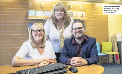  ??  ?? Back in business Manager Alan Daly and staff at Hays Travel in Airdrie