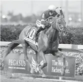  ?? LYNNE SLADKY/AP ?? Jockey Florent Geroux rides Gun Runner to victory in the Pegasus World Cup Invitation­al at Gulfstream Park in January 2017.