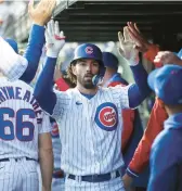  ?? TRIBUNE CHRIS SWEDA/CHICAGO ?? Cubs shortstop Dansby Swanson is congratula­ted by teammates in the dugout after hitting a two-run home run against the Cardinals on Tuesday.