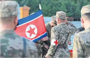  ?? AFP ?? A military medic of the Korean People’s Army salutes a flag in Pyongyang yesterday.