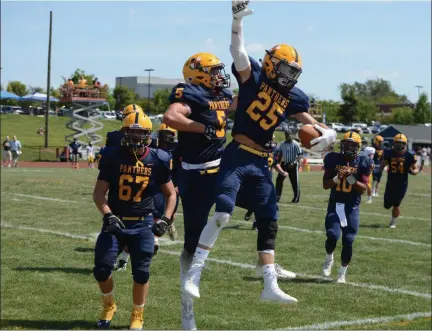  ?? OWEN MCCUE - MEDIANEWS GROUP ?? Above, Pope John Paul II wide receiver Steve Skarbek (25) and his Golden Panthers’ teammates celebrate his touchdown grab over a New Hope-Solebury defender, pictured below, in Saturday’s win.