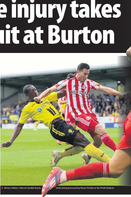  ??  ?? Burton Albion’ s Marvin Sordell shoots while being pressured by Bryan Oviedo at the Pirelli Stadium
