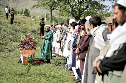  ?? AP Photo/Massoud Hossaini ?? ■ Relatives, colleagues and friends of news photograph­er Shah Marai, who was killed in a second suicide attack Monday, participat­e in a prayer in his village, Gul Dara, a district of Kabul province, Afghanista­n. A coordinate­d double suicide bombing by...