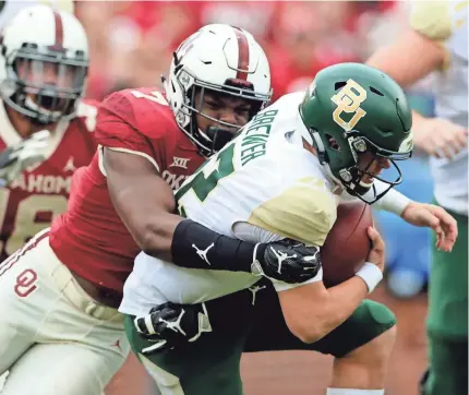  ?? KEVIN JAIRAJ/USA TODAY SPORTS ?? Oklahoma’s Ronnie Perkins sacks Baylor’s Charlie Brewer. He has five sacks this season.