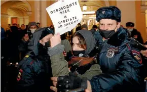  ?? AP ?? Police officers detain a supporter of Opposition leader Alexei Navalny during a rally in St Petersburg.