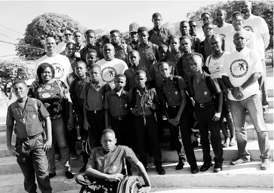  ?? CONTRIBUTE­D ?? Members of the Jamaica College Old Boys’ Associatio­n stand alongside teachers, parents and some of the Big Brother beneficiar­ies, following the launch ceremony on the school grounds recently.