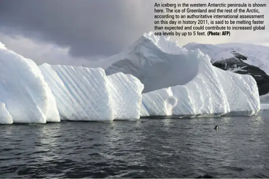  ?? (Photo: AFP) ?? An iceberg in the western Antarctic peninsula is shown here. The ice of Greenland and the rest of the Arctic, according to an authoritat­ive internatio­nal assessment on this day in history 2011, is said to be melting faster than expected and could contribute to increased global sea levels by up to 5 feet.