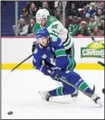  ?? ?? Vancouver Canucks’ Elias Pettersson (40) is checked by Dallas Stars’ Radek Faksa (12) during the third period of an NHL hockey game in Vancouver, British Columbia. (AP)